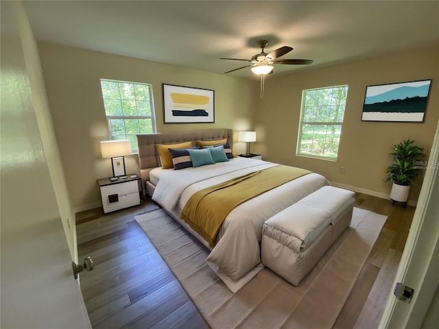 bedroom with ceiling fan and wood-type flooring