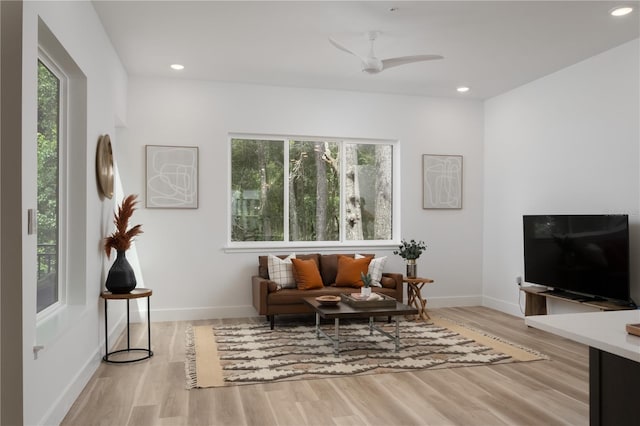 living area featuring light hardwood / wood-style flooring, plenty of natural light, and ceiling fan