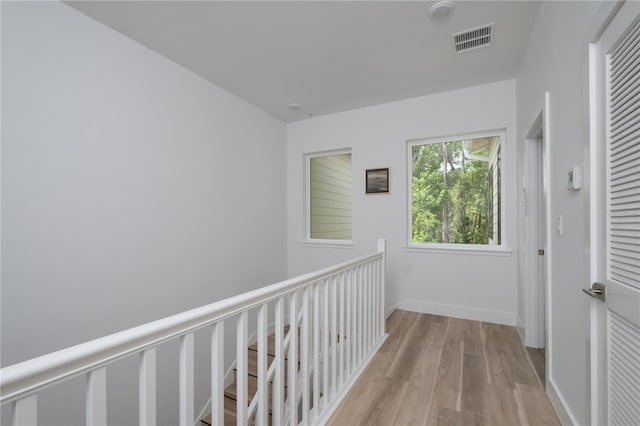 hallway with light hardwood / wood-style floors