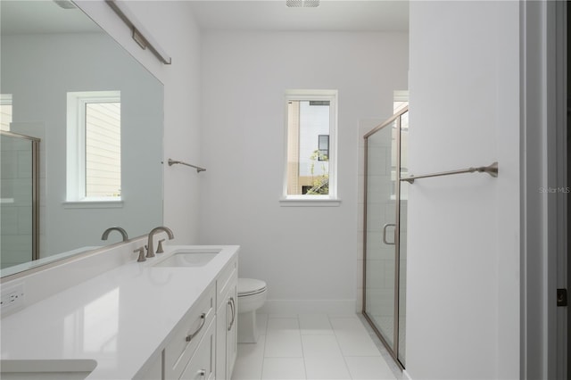 bathroom featuring tile patterned floors, vanity, toilet, and a shower with shower door