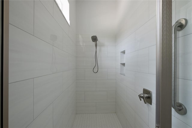 bathroom with a tile shower