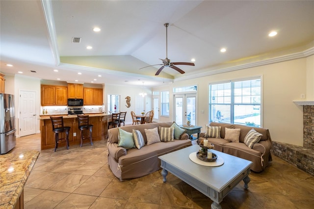 living room with ceiling fan, crown molding, and vaulted ceiling