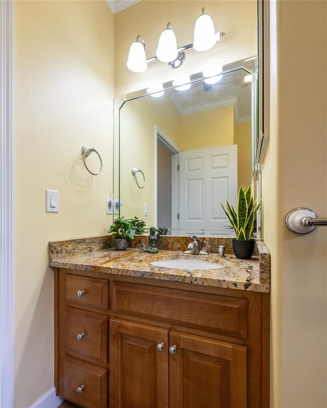 bathroom featuring vanity and ornamental molding