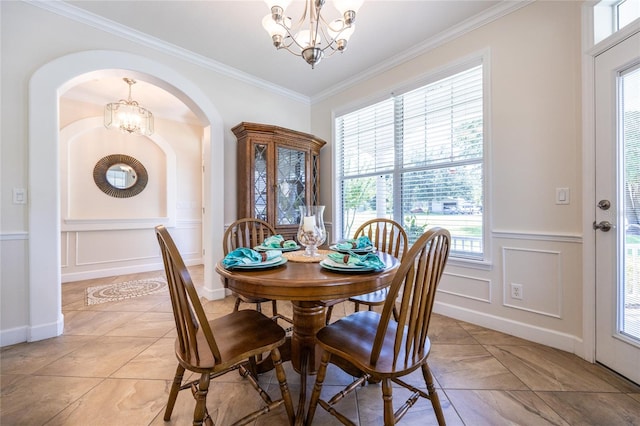 dining space with a chandelier, plenty of natural light, and crown molding