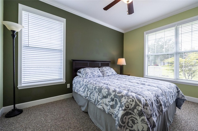 carpeted bedroom featuring ceiling fan and ornamental molding