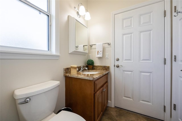 bathroom with tile patterned floors, vanity, and toilet