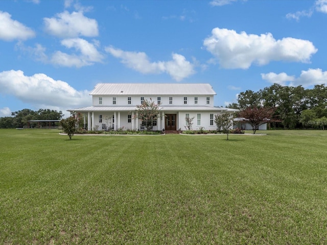 rear view of house with a yard and covered porch