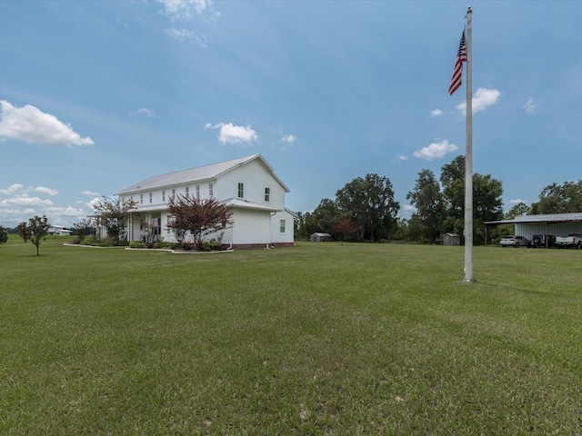 view of side of home with a yard