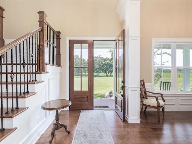 entrance foyer with dark hardwood / wood-style floors and a towering ceiling