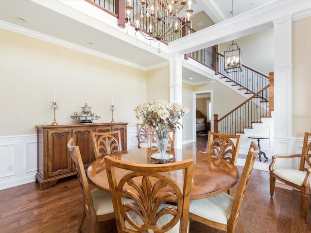 dining area with crown molding, an inviting chandelier, and a high ceiling