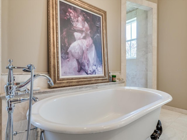 bathroom featuring tile floors and a washtub