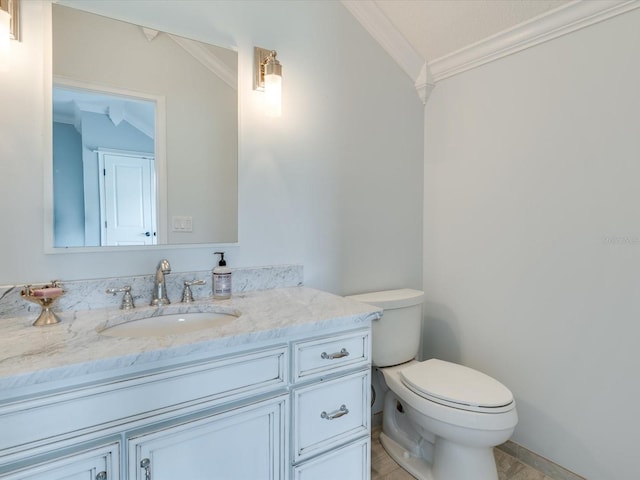 bathroom featuring toilet, crown molding, oversized vanity, and vaulted ceiling