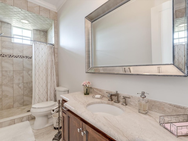 bathroom with curtained shower, toilet, vanity with extensive cabinet space, and a healthy amount of sunlight