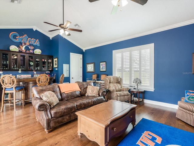 living room with ornamental molding and ceiling fan