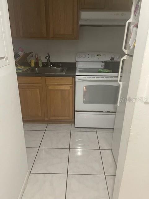 kitchen featuring light tile floors, sink, wall chimney exhaust hood, and white electric range