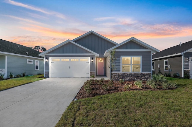 craftsman-style home featuring a garage and a lawn