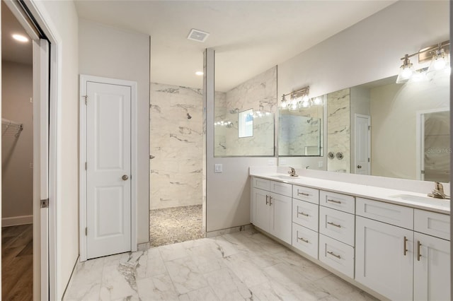 bathroom featuring vanity and a tile shower