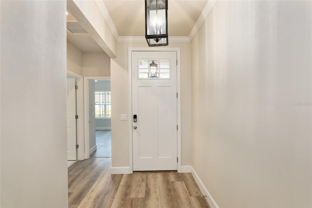 entrance foyer featuring light hardwood / wood-style flooring and ornamental molding