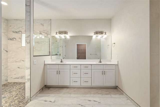 bathroom featuring a tile shower and vanity