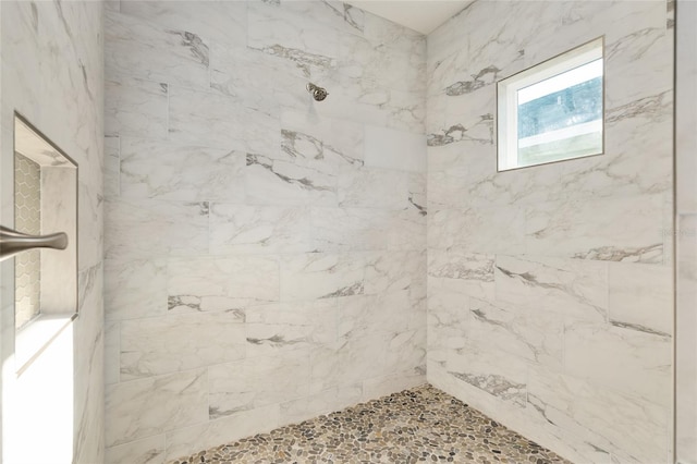 bathroom featuring a tile shower