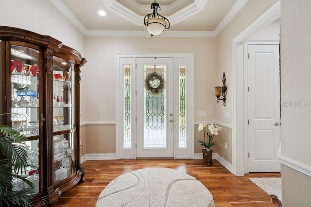 entryway featuring a wealth of natural light, wood-type flooring, and crown molding