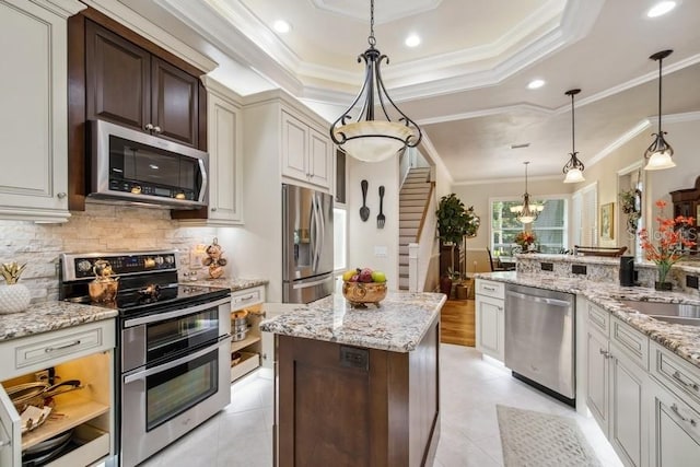 kitchen featuring stainless steel appliances, dark brown cabinets, decorative light fixtures, and crown molding