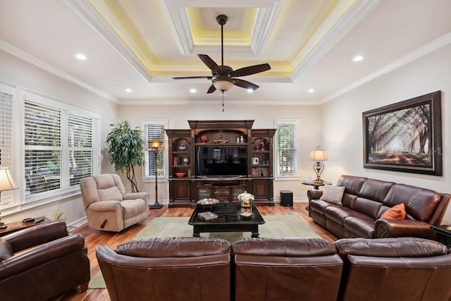 living room featuring ceiling fan, light wood-type flooring, and crown molding