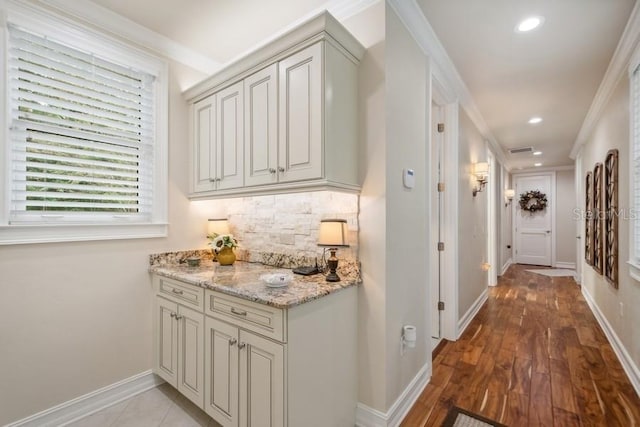 hall featuring light hardwood / wood-style floors and crown molding