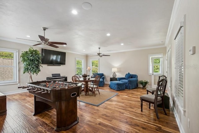 playroom featuring hardwood / wood-style flooring, ceiling fan, plenty of natural light, and ornamental molding