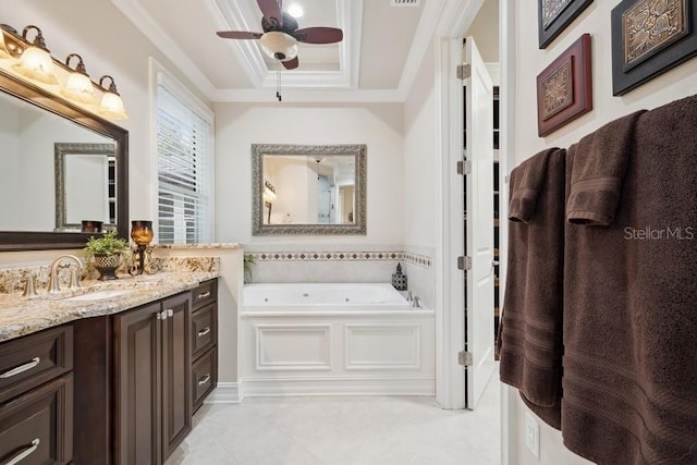 bathroom featuring ceiling fan, a tray ceiling, vanity, a bathing tub, and crown molding