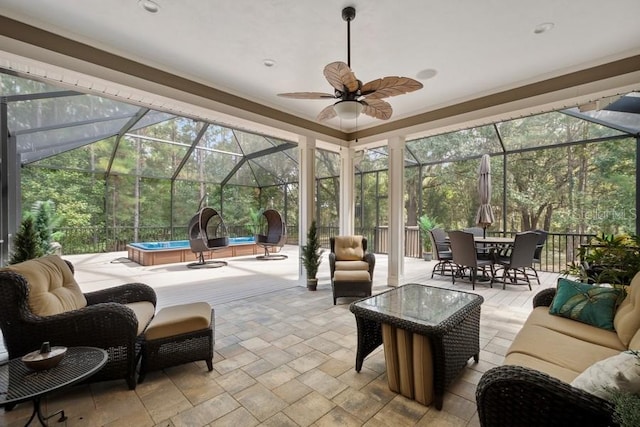 sunroom with ceiling fan and a healthy amount of sunlight