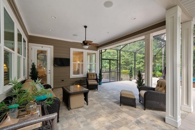 sunroom / solarium featuring ceiling fan