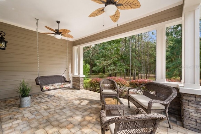 sunroom / solarium featuring ceiling fan