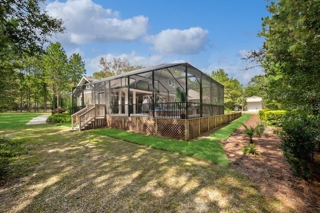 back of house with a lanai and a yard