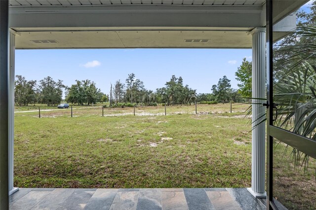 view of yard with a rural view