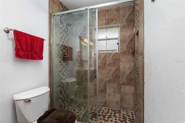 bathroom featuring an enclosed shower and toilet