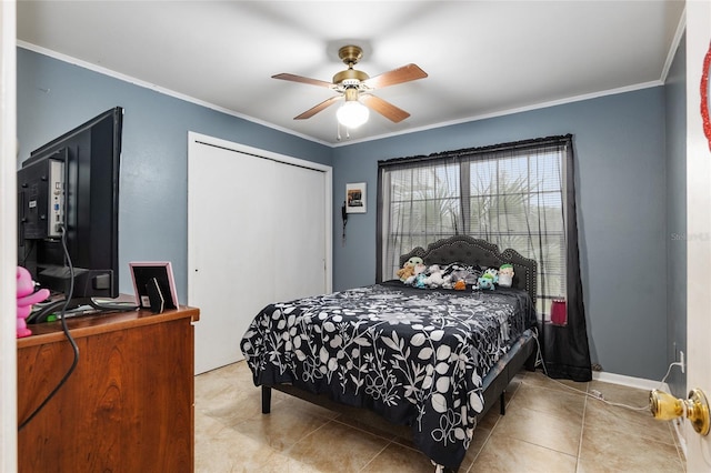 tiled bedroom featuring ornamental molding, ceiling fan, and a closet