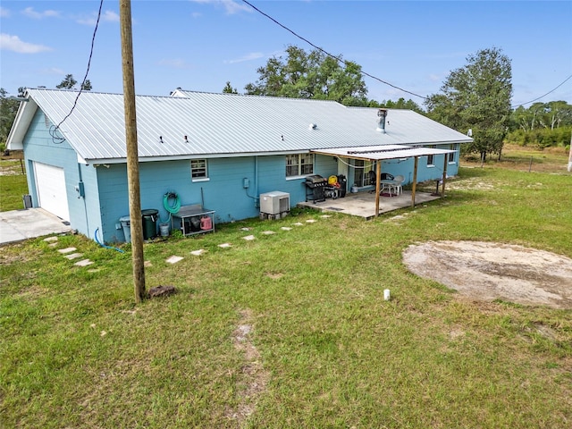 back of property featuring a lawn and a patio