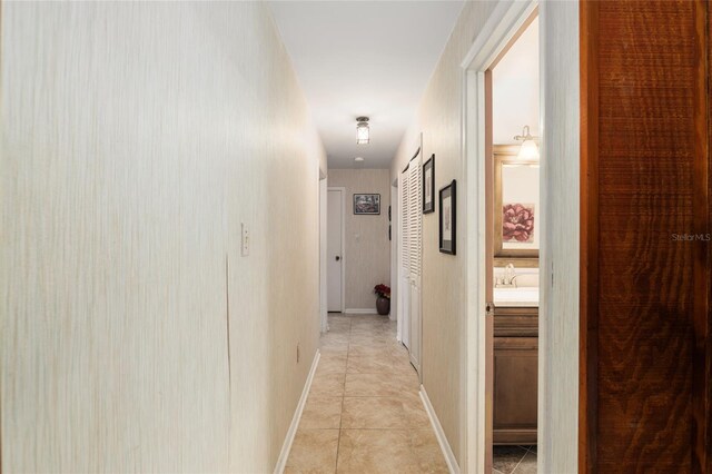 hall with light tile patterned floors