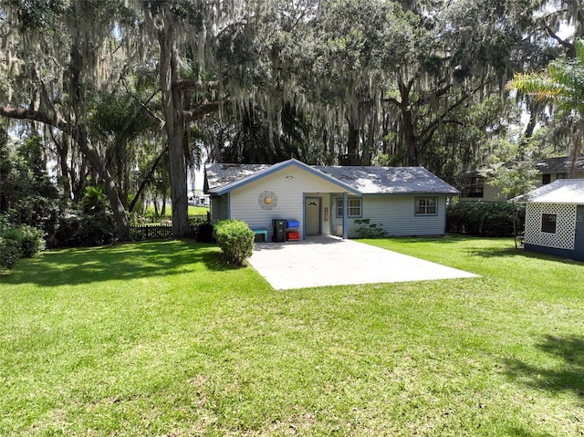 rear view of house featuring a yard and a patio area