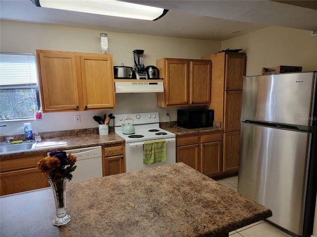 kitchen with sink, white appliances, and light tile patterned floors