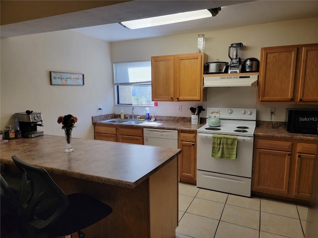 kitchen with sink, white appliances, a kitchen breakfast bar, and light tile patterned floors