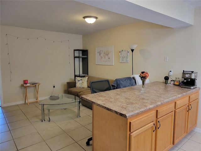 kitchen with light brown cabinetry and light tile patterned floors