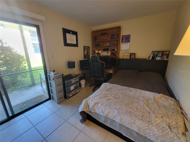 bedroom with light tile patterned floors and access to outside