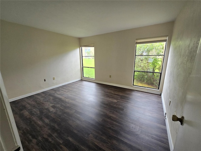 spare room featuring dark wood-type flooring