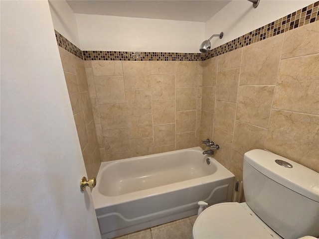 bathroom with toilet, tile patterned floors, and tiled shower / bath