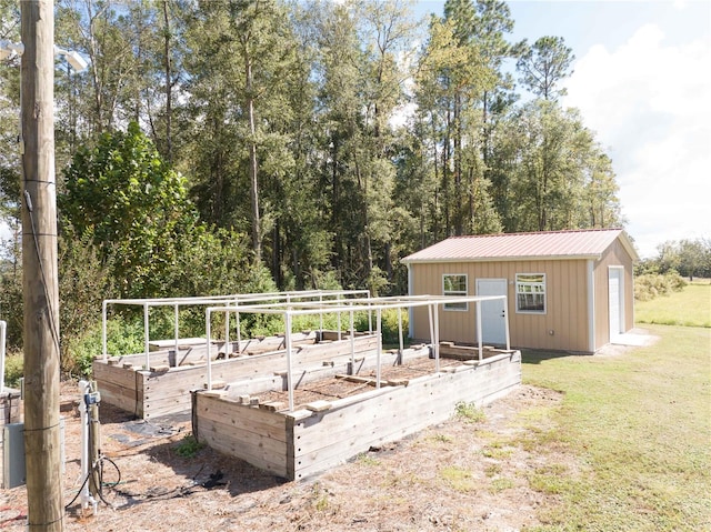 back of house featuring a lawn and an outdoor structure