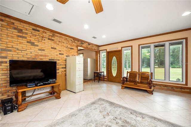 interior space featuring brick wall, ceiling fan, light tile flooring, and a fireplace