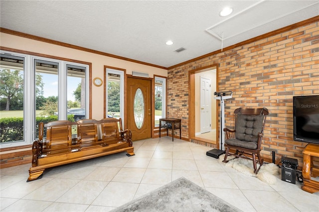 interior space with brick wall, a textured ceiling, and crown molding