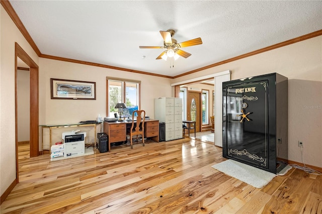 home office featuring ceiling fan, light wood-type flooring, and crown molding